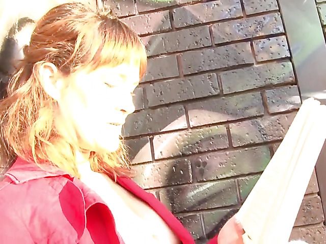 Pretty MILF in red reading and masturbating in public