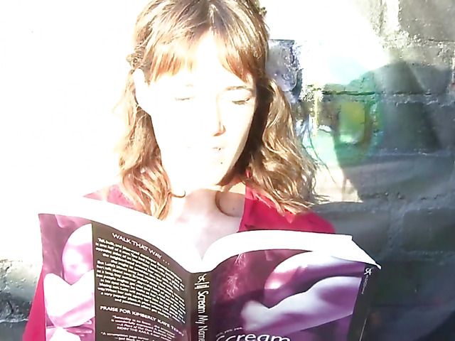 Pretty MILF in red reading and masturbating in public