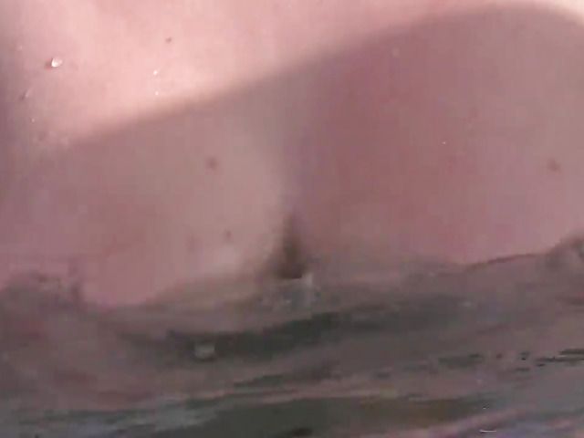 Blonde flaunts her huge natural tits in the pool