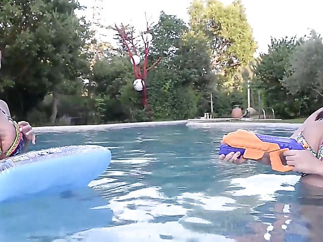 Huge tits women play with water guns topless