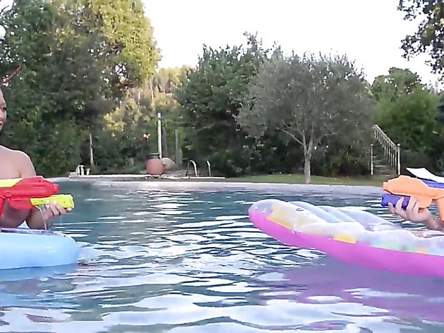 Huge tits women play with water guns topless
