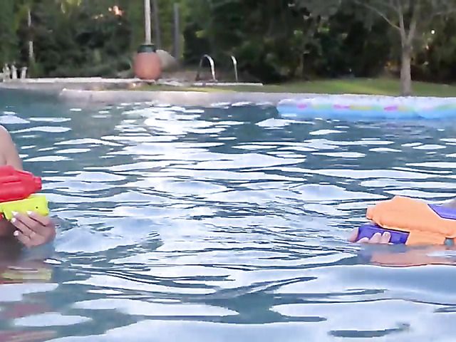 Huge tits women play with water guns topless