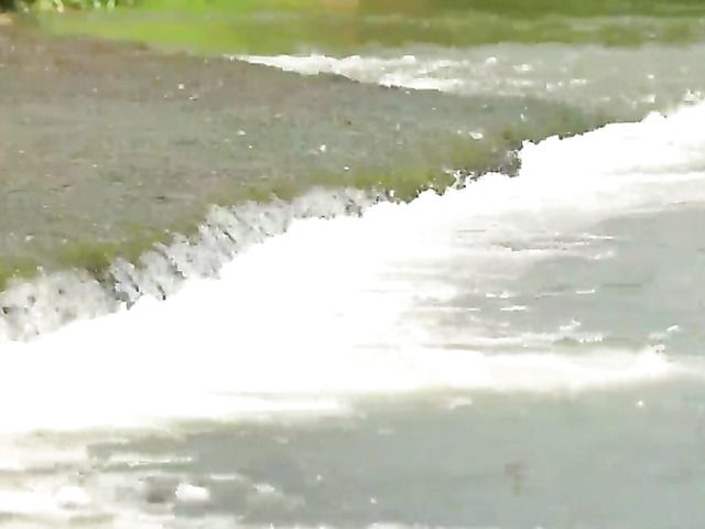 Naked blonde with hairy pussy gets all wet by water