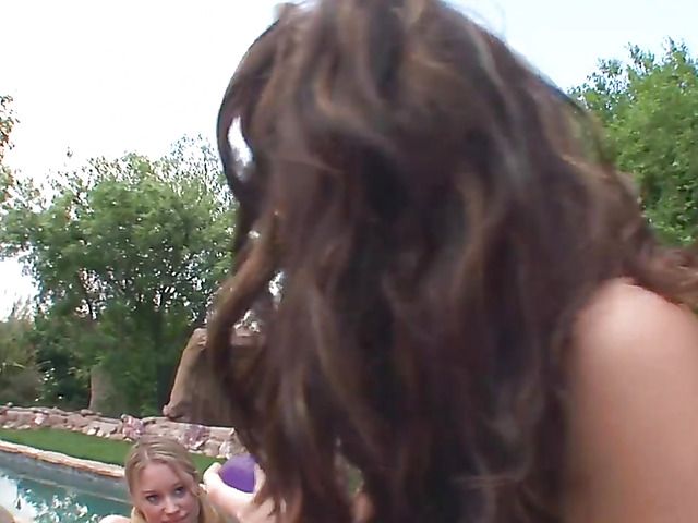 Young lesbian cuties sharing dildo by the pool