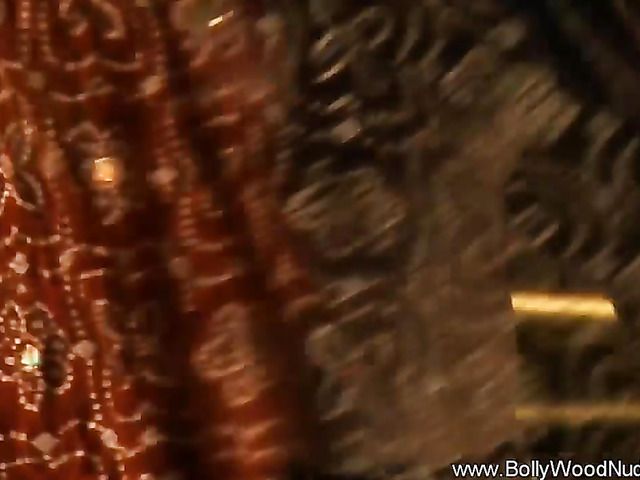 Busty Indian babe strips naked and gets wet