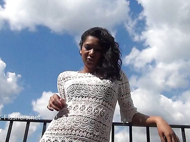 Hot brunette displays her shaved pussy in public