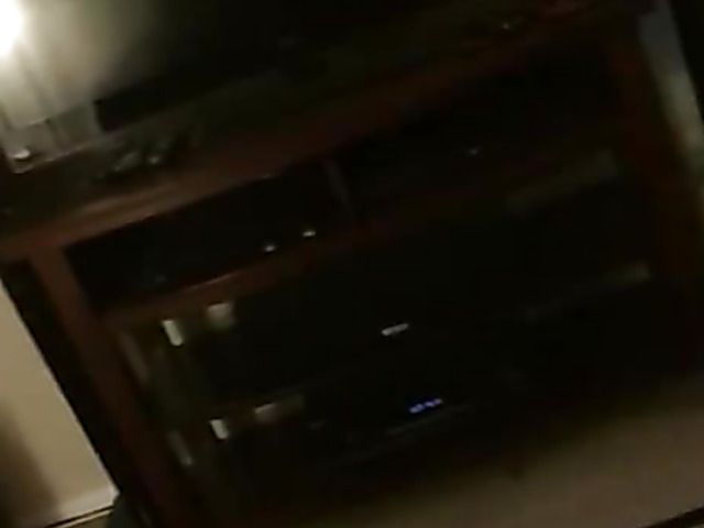 Holding the phone and spraying her face