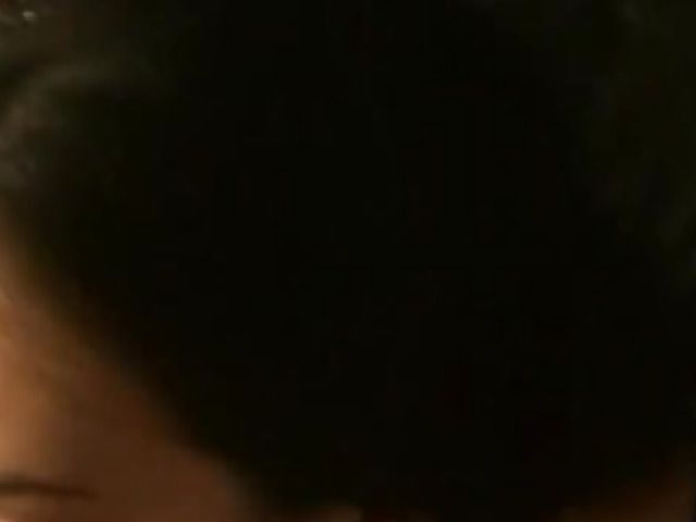 Holding the phone and spraying her face