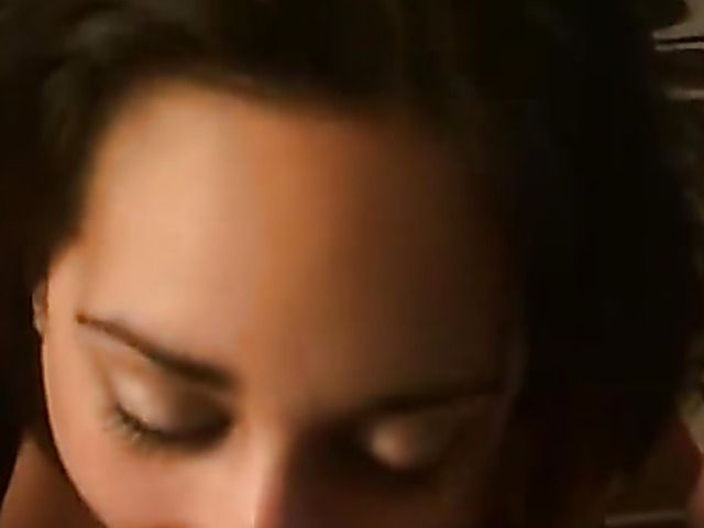 Holding the phone and spraying her face