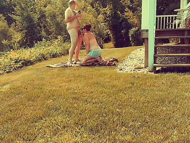 Fat wife in sunglasses gives head in the open air