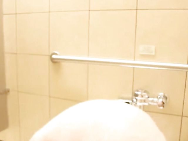 Busty Asian teen toys her slit in the public bathroom