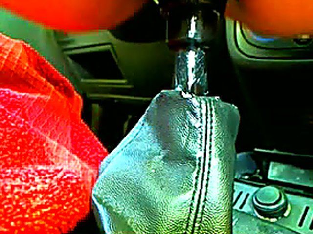 Frustrated babe sits on a cars gear box