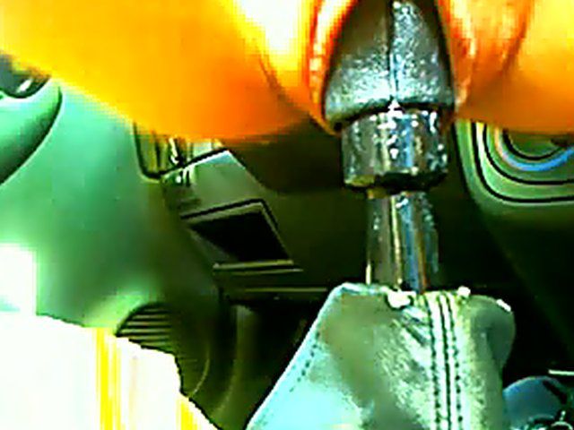 Frustrated babe sits on a cars gear box