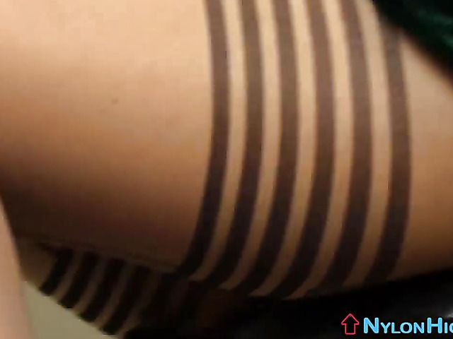 Brunette shows off her pantyhose feet and bares her ass