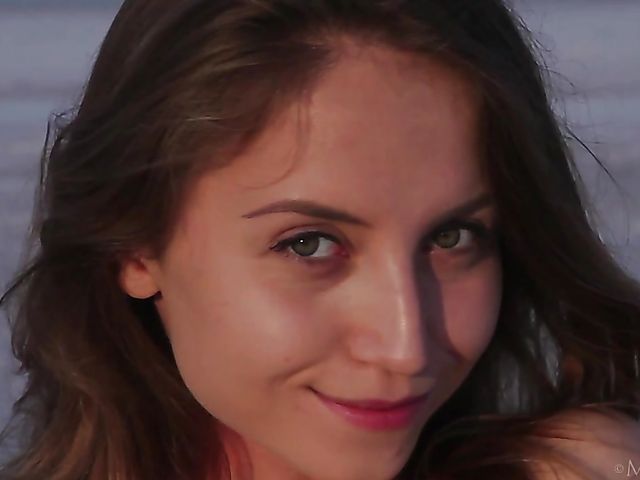 Nude teen model Nicolina posing outside