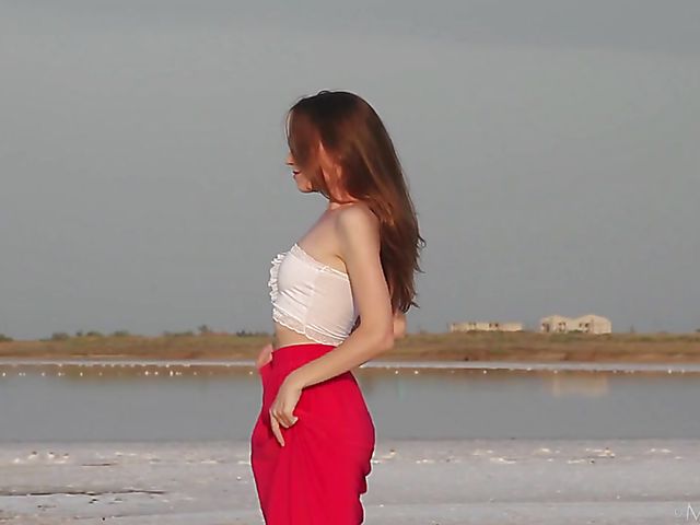 Nude teen model Nicolina posing outside