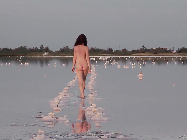 Nude teen model Nicolina posing outside