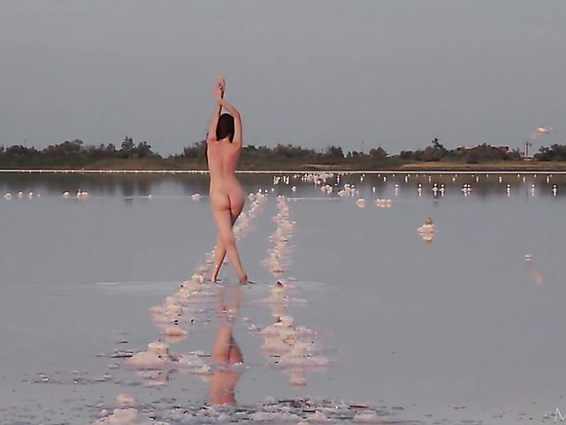 Nude teen model Nicolina posing outside