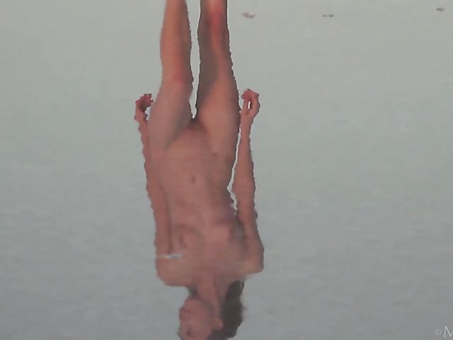 Nude teen model Nicolina posing outside