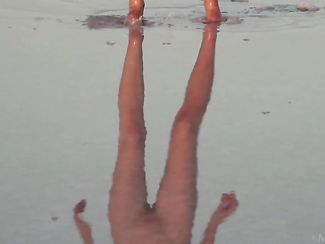 Nude teen model Nicolina posing outside