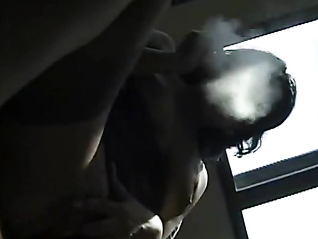 Smoking MILF touches her boobs and slit