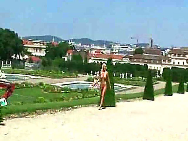 Glamorous blonde walks around outside naked in public