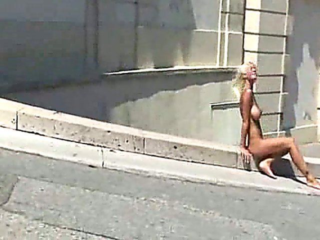 Glamorous blonde walks around outside naked in public