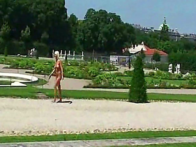 Glamorous blonde walks around outside naked in public