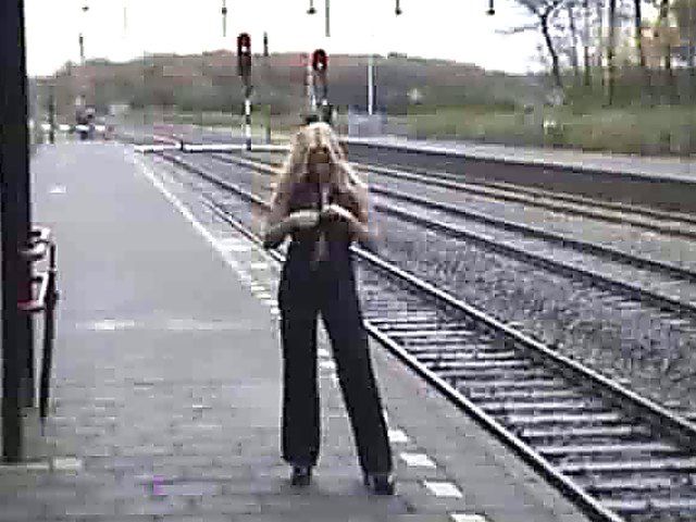 Beautiful blonde with big tits posses naked outside