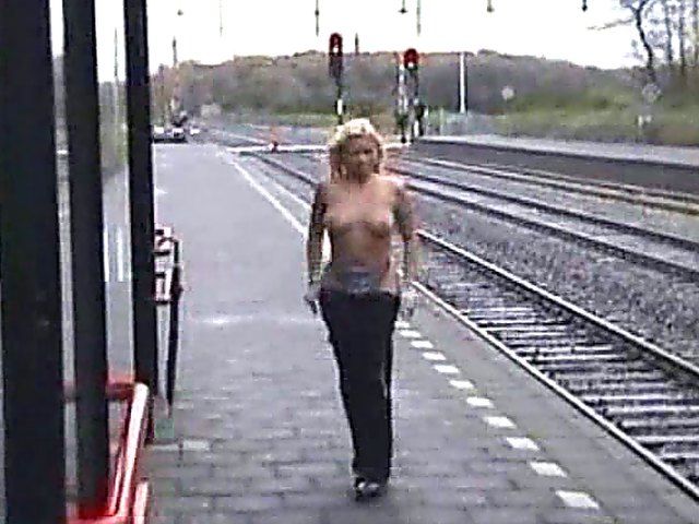 Beautiful blonde with big tits posses naked outside