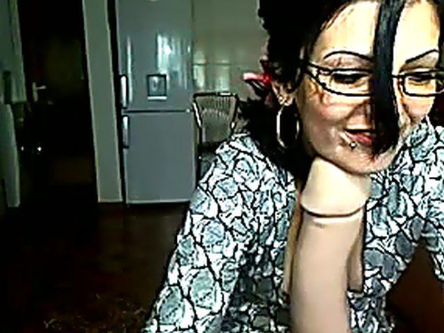Pretty brunette strokes her pussy in the kitchen