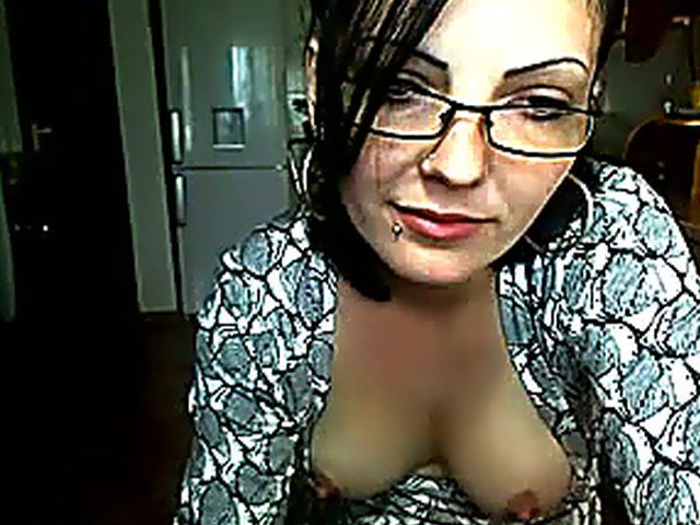 Pretty brunette strokes her pussy in the kitchen