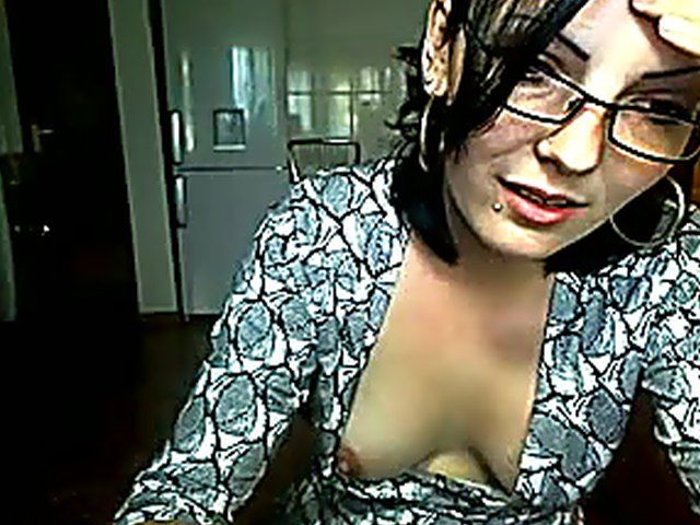 Pretty brunette strokes her pussy in the kitchen