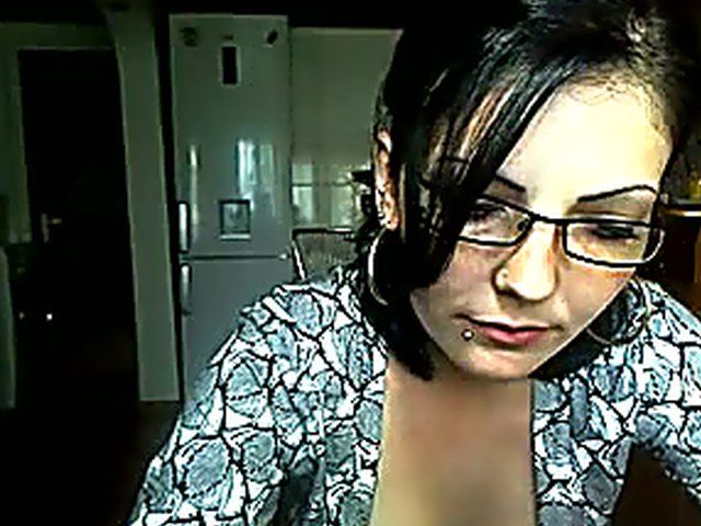 Pretty brunette strokes her pussy in the kitchen