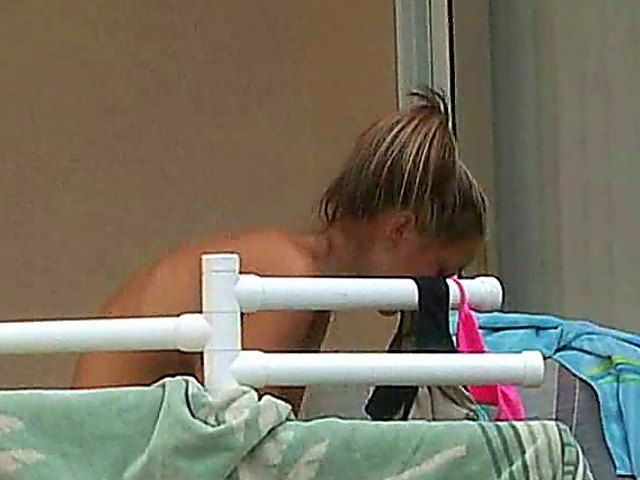 Stunning blonde with big tits posses and strips